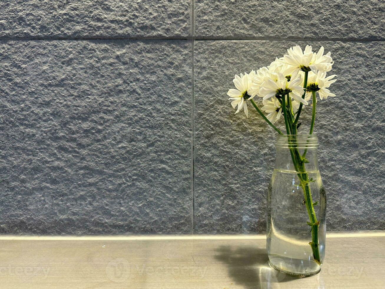 Beautiful white flower decoration with gray textured walls photo