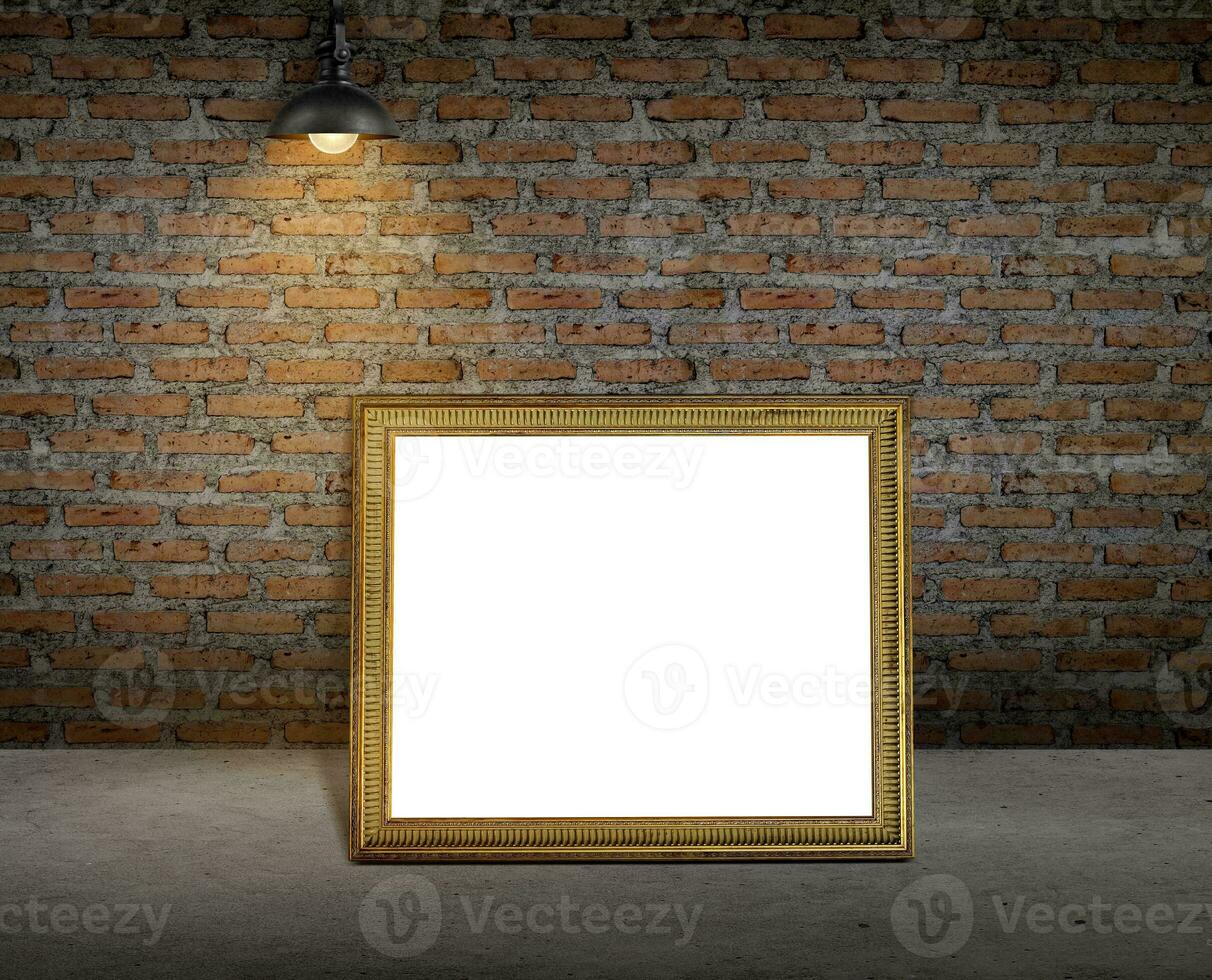 Golden picture frame on dark brick wall photo