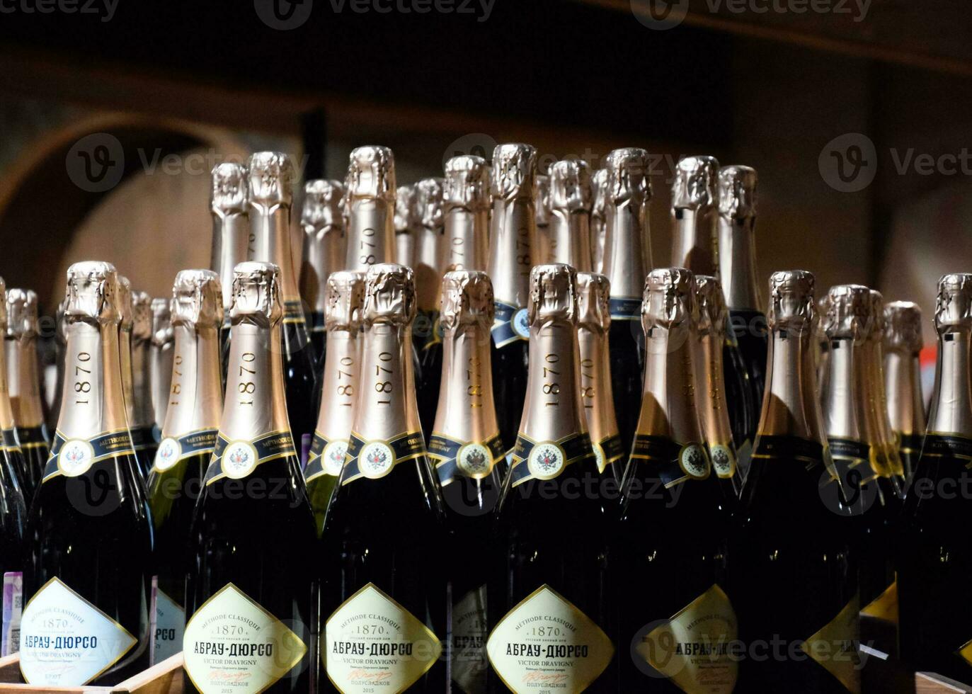 Bottles of champagne on the counter. Shelves with wine and champagne in the store winery. Counter at the winery. photo