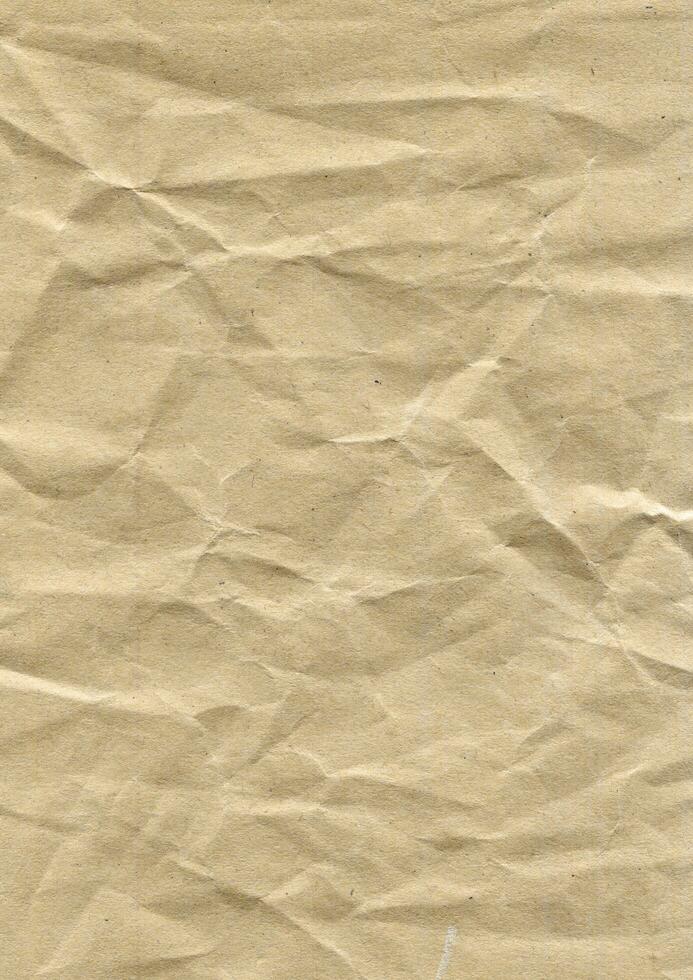 Brown wrinkled paper texture photo background. Old crumpled grunge paper surface backdrop.