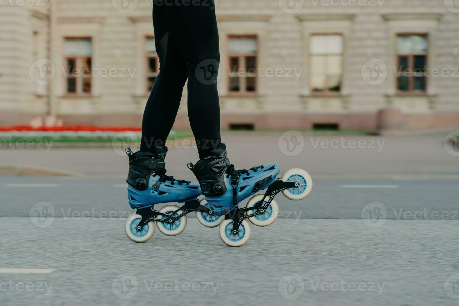 Cropped shot of faceless woman wears rollerblades for riding on road enjoys hobby in fresh air has active lifestyle tries new rollers after purchasing. People hobby and outdoor free time activities photo