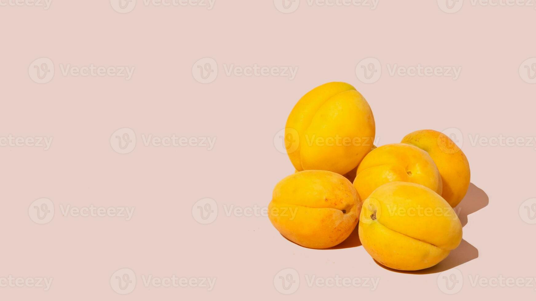 Apricots isolated on pink backgound, copy space photo