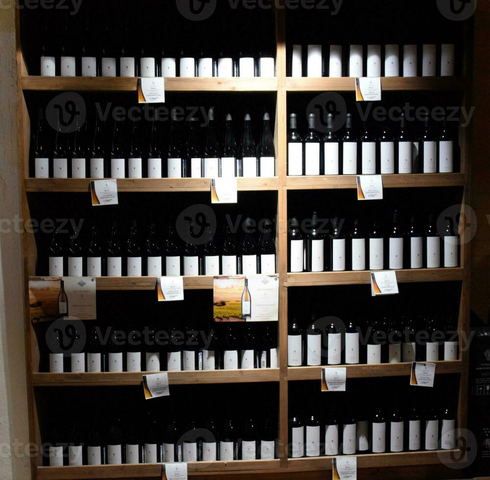 Shelves with wine and champagne in the store winery. Counter at the winery. photo