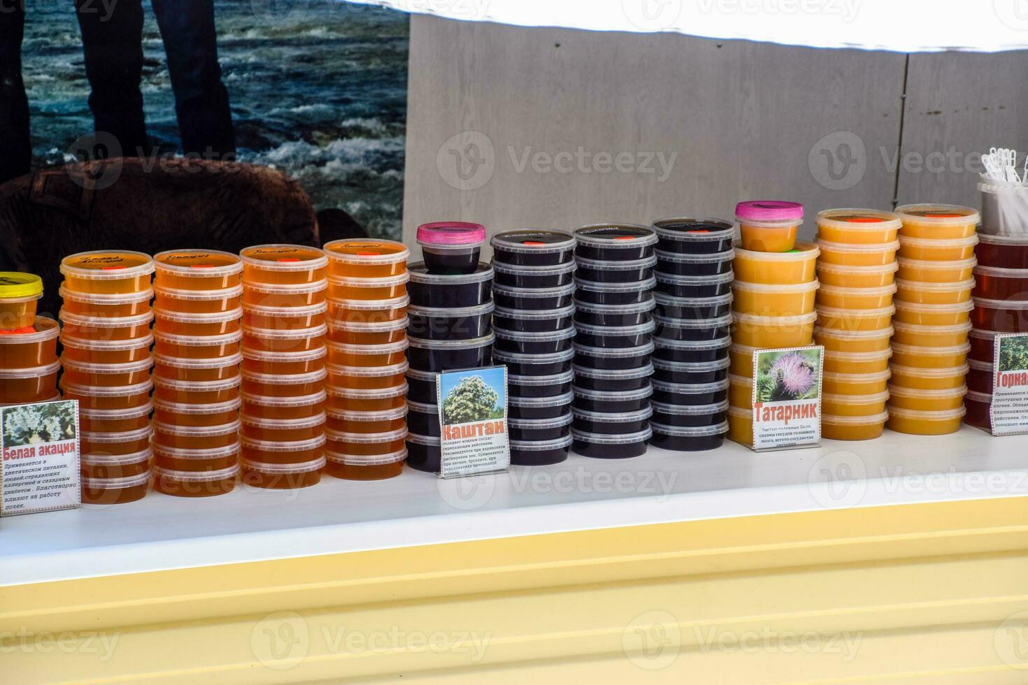 Counter with honey. Different types of honey in cans. Sale of honey. photo