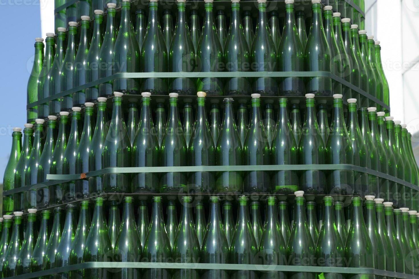 Christmas tree of bottles of champagne. Creative from bottles. Empty bottles of champagne photo