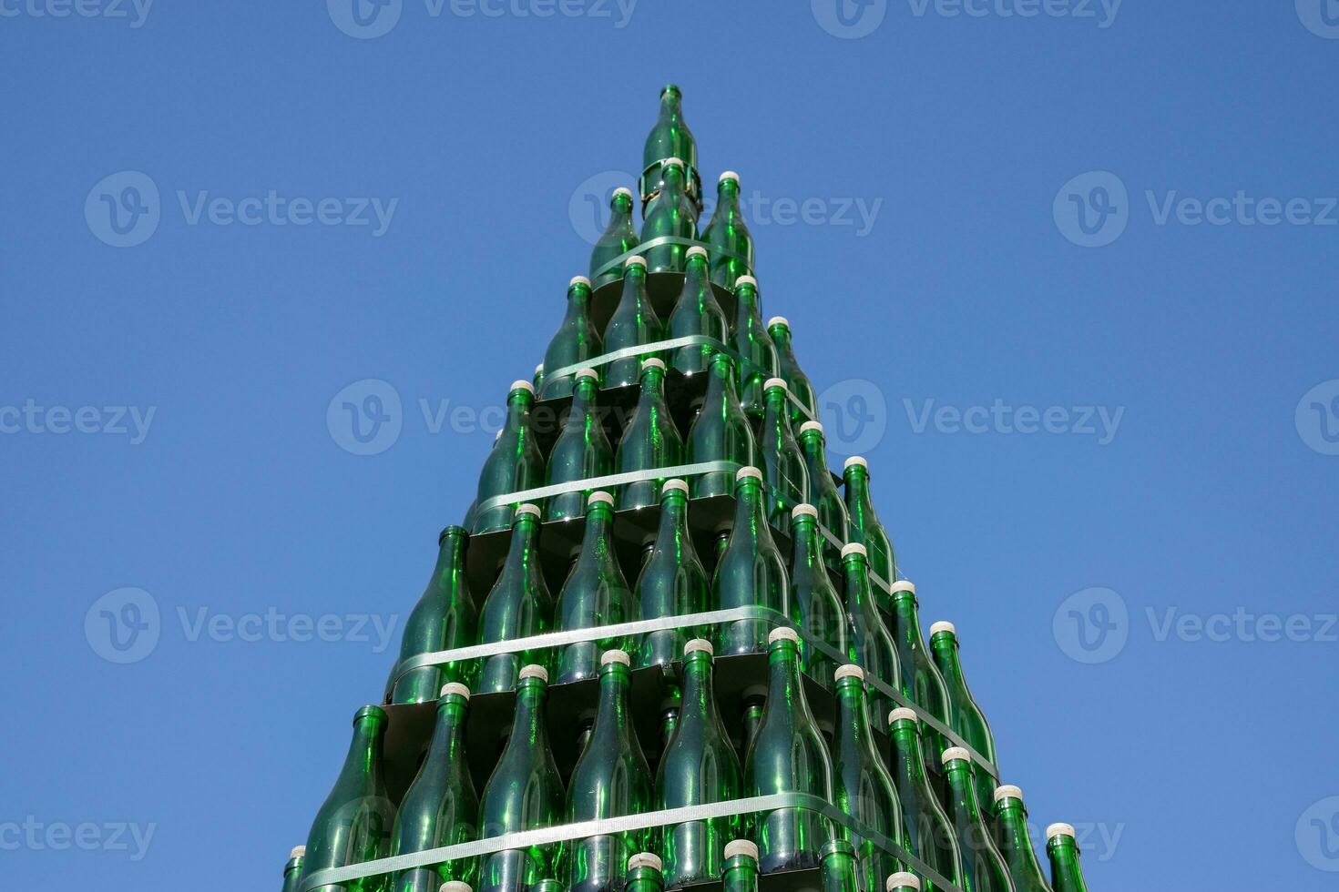 Christmas tree of bottles of champagne. Creative from bottles. Empty bottles of champagne photo