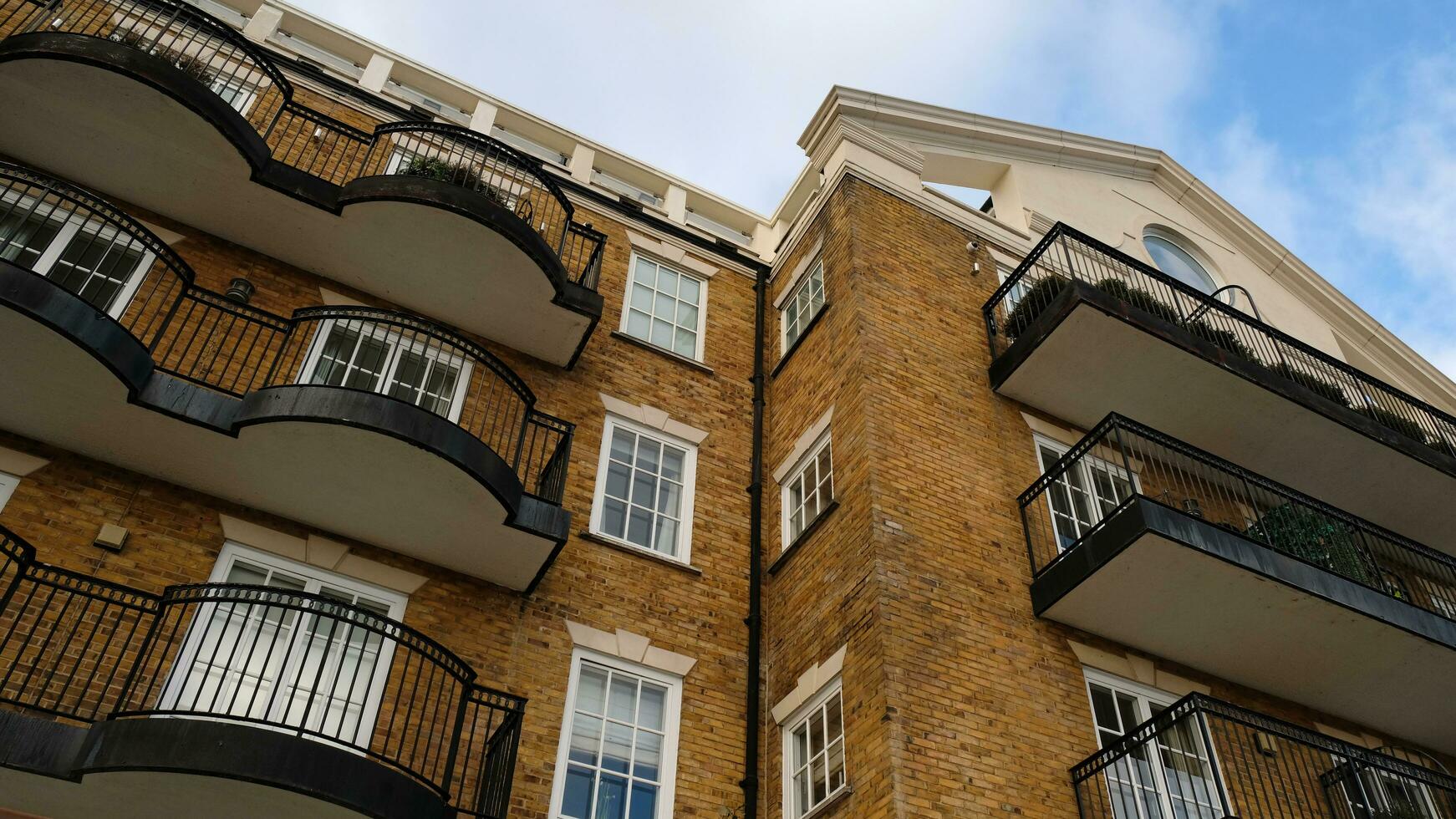 Exterior of modern brick house object. Architectural detail of a skyscraper, close-up on the windows. Real estate, residential apartments and offices. Living apartments or office building architecture photo