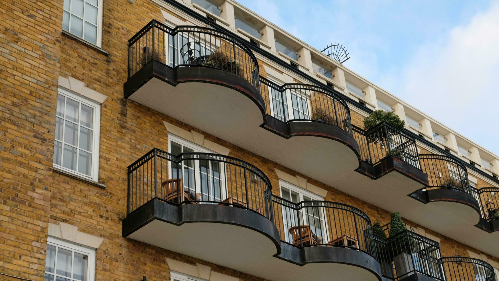 Exterior of modern brick house object. Architectural detail of a skyscraper, close-up on the windows. Real estate, residential apartments and offices. Living apartments or office building architecture photo