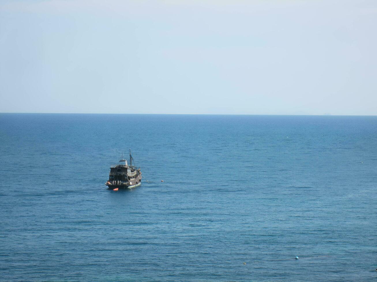 A fishing boat and the vast sea photo