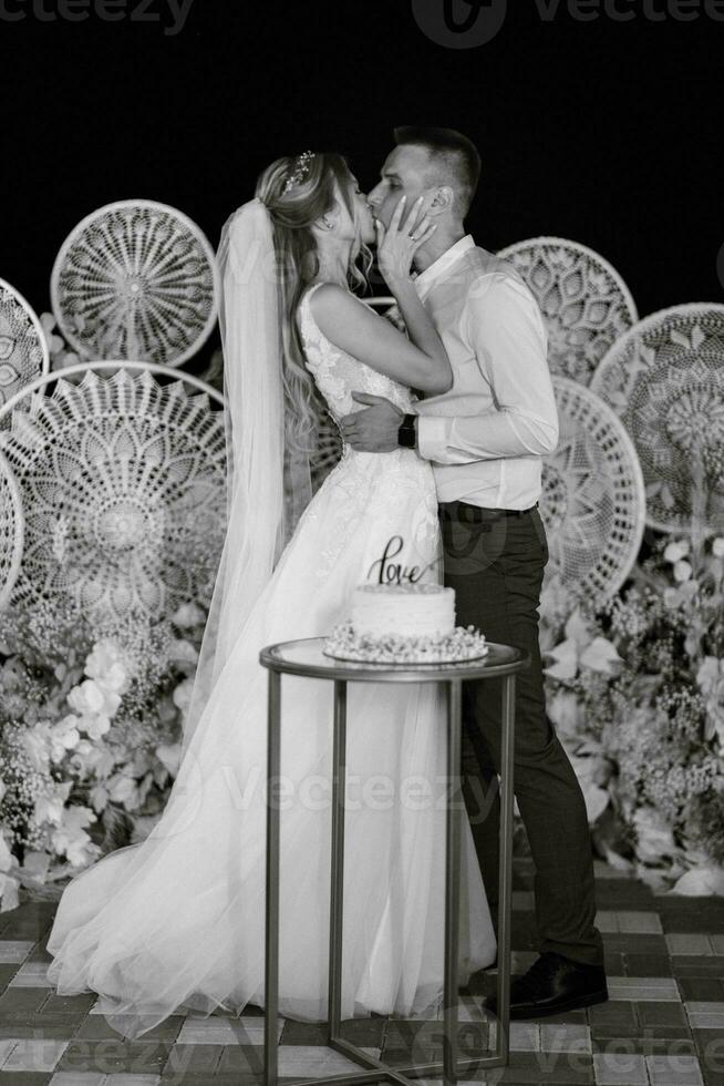 newlyweds happily cut and taste the wedding cake photo