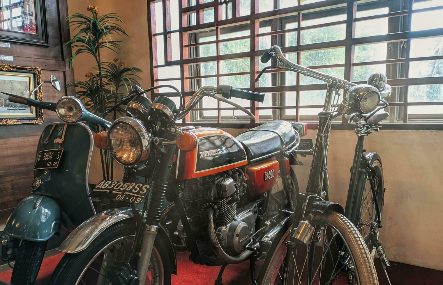 Toba, Indonesia, June 2023 - a collection of antique TB Silalahi motorbikes, Vespa and Honda CB and ontel bikes.  three antique vehicles in the TB Silalahi museum. photo