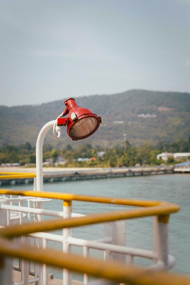 Search light attached to the side of a ship. photo