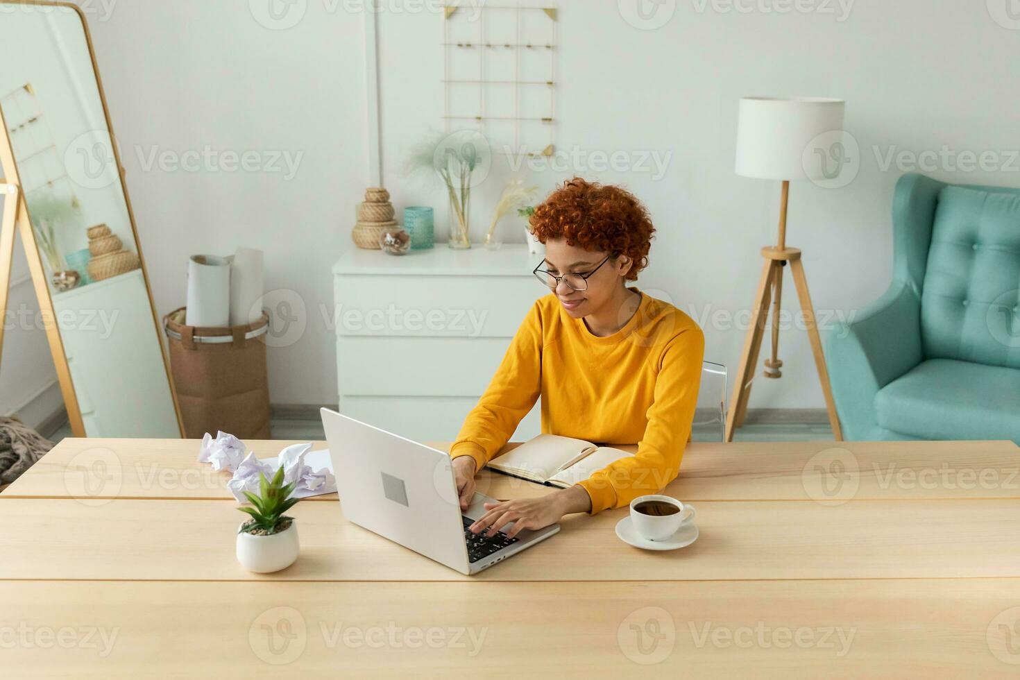 African american girl using laptop at home office looking at screen typing chatting reading writing email. Young woman having virtual meeting online chat video call conference Work learning from home photo