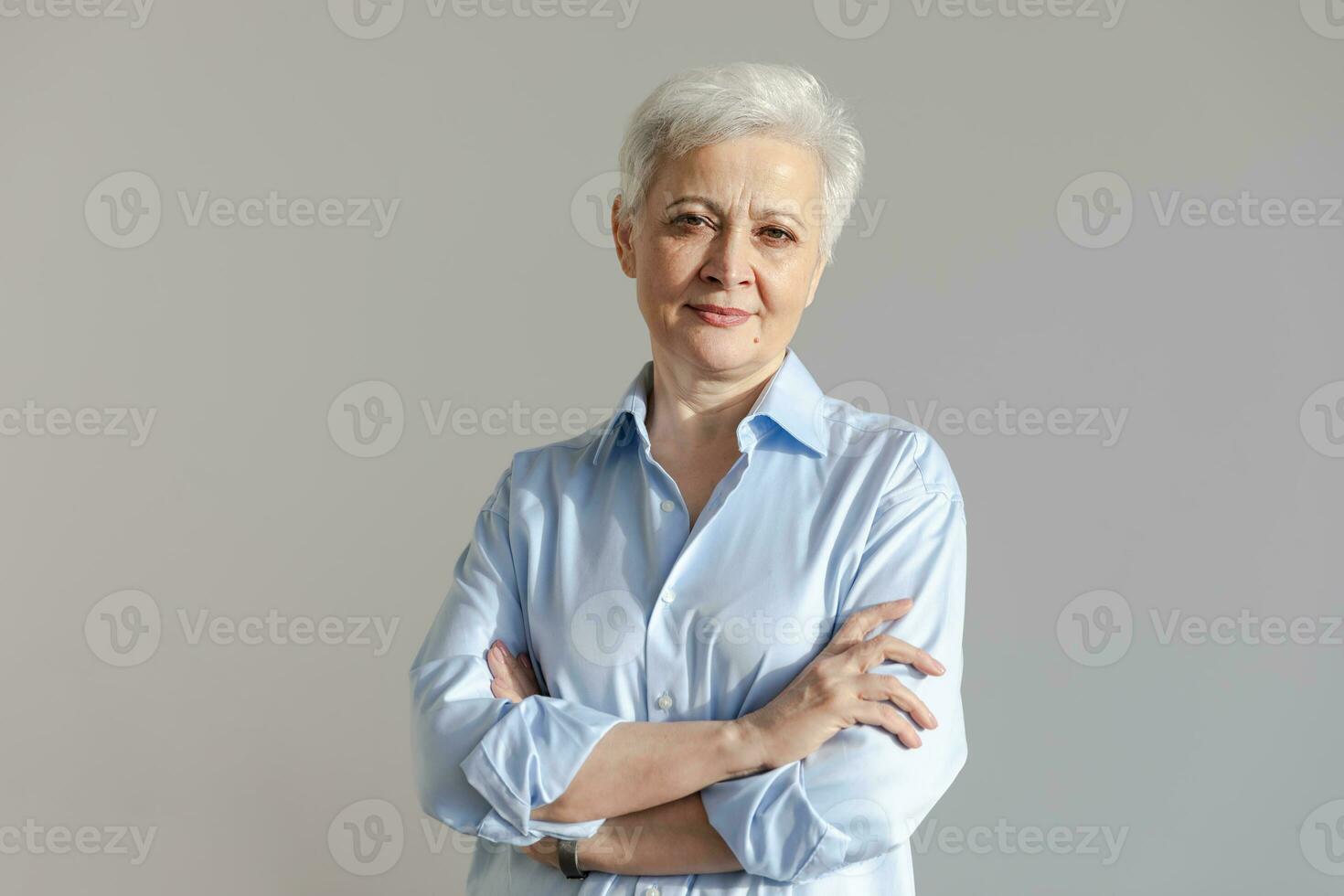 Confident stylish european middle aged senior woman. Older mature 60s lady smiling in white background. Happy attractive senior female looking camera close up face headshot portrait. Happy people. photo