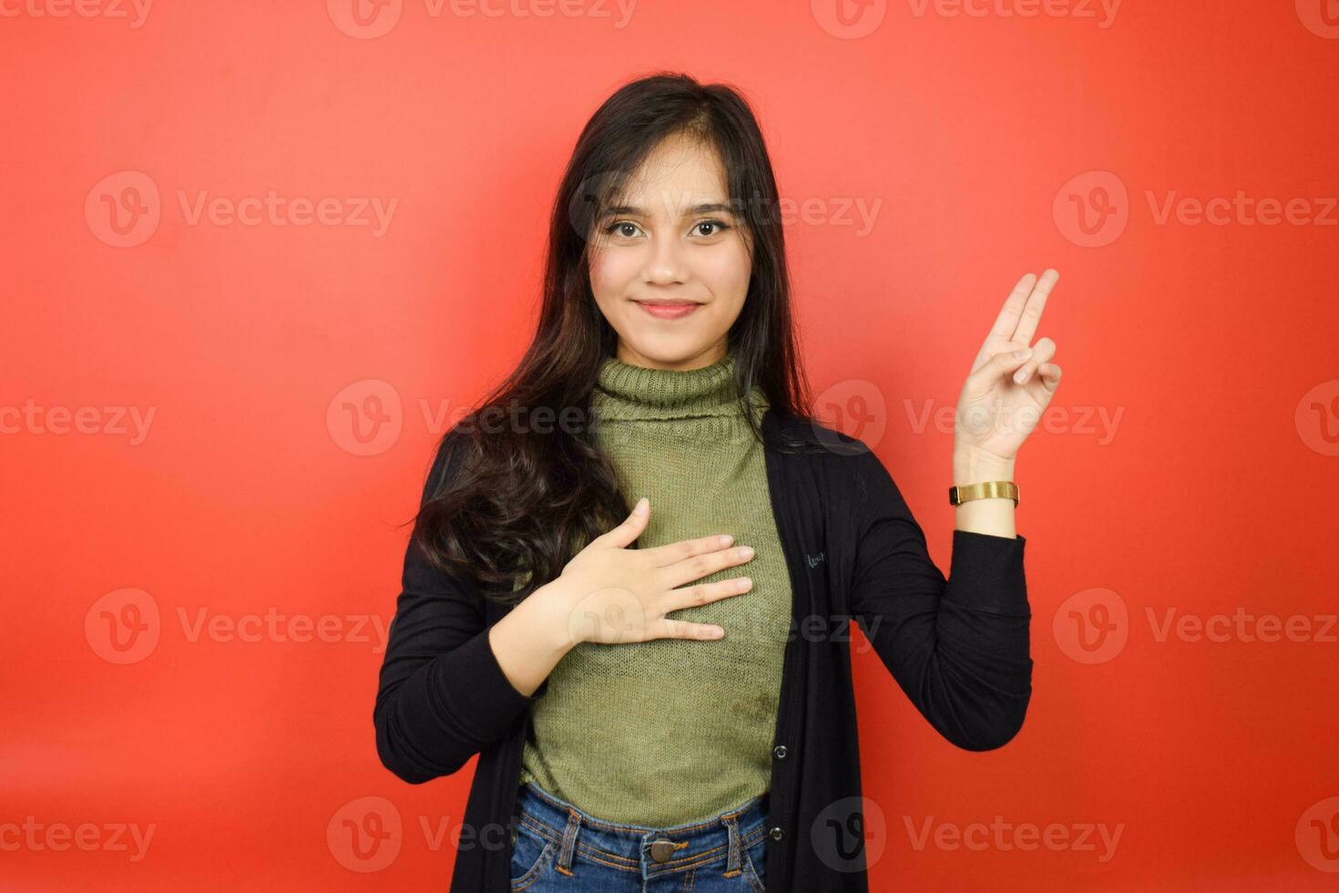 Swearing Gesture, Make an Oath Of Beautiful Asian Woman Isolated On Red Background photo