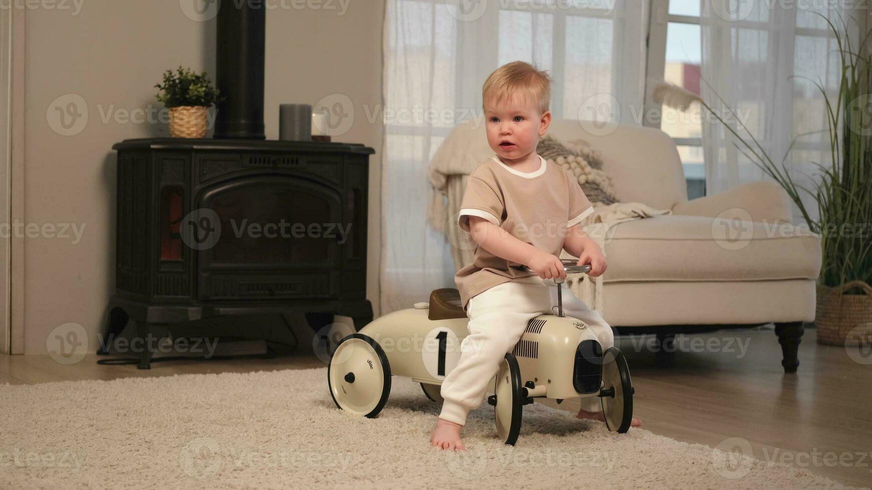 Happy child at home. Little toddler boy driving big vintage toy car and having fun. Smiling kid playing at home. Baby boy playing with toy in living room indoors. photo