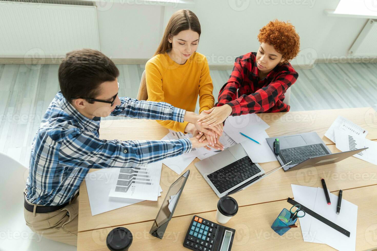 Stack of hands. Business startup teamwork unity concept. Top view of young business people putting their hands together. Business colleagues during the work process rejoice in success of company photo