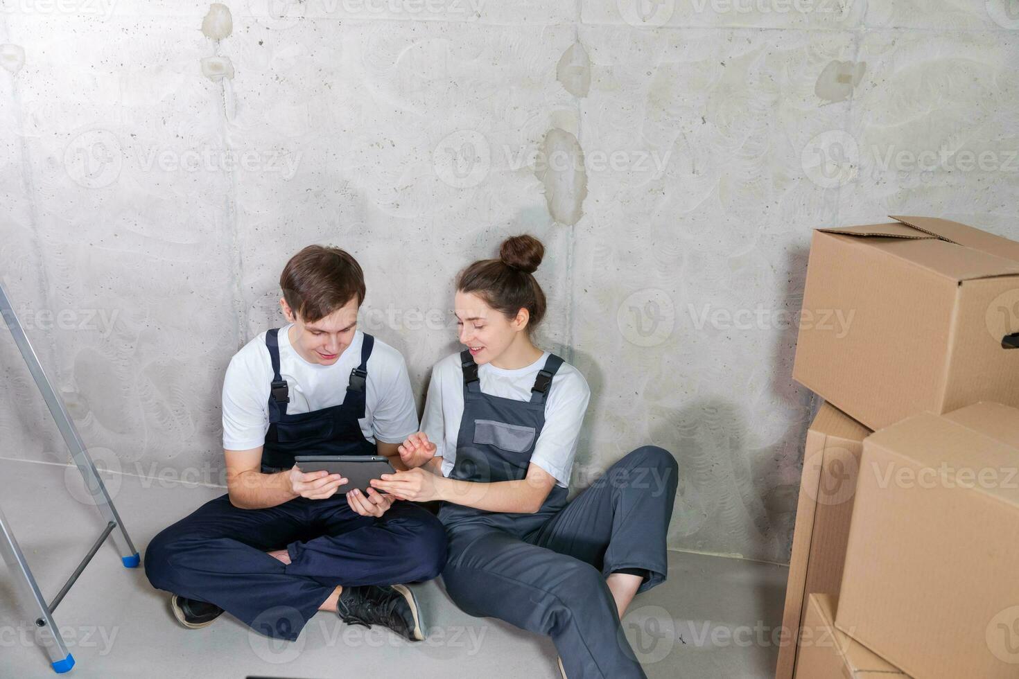 Couple in new home during repair works discussing about home design project looking repair plan on tablet. Happy family choosing new decorations and design. Home renovation DIY renew makeover concept. photo