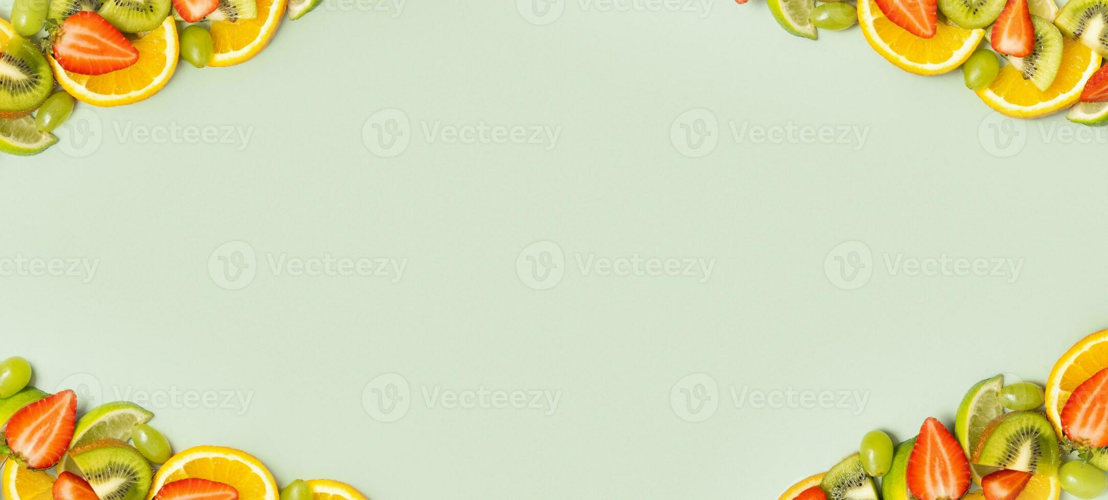 Citrus fruits, kiwi and strawberries flat lay, top view. Summer  banner background with copy space photo