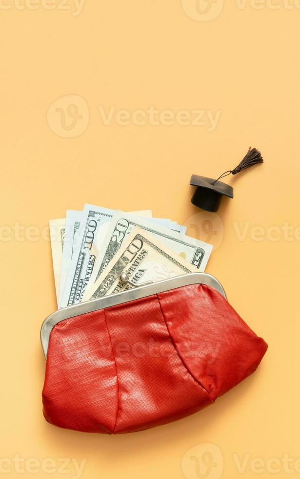 Graduated cap with dollars  cash in wallet. Grant for education, back to school allowance concept photo