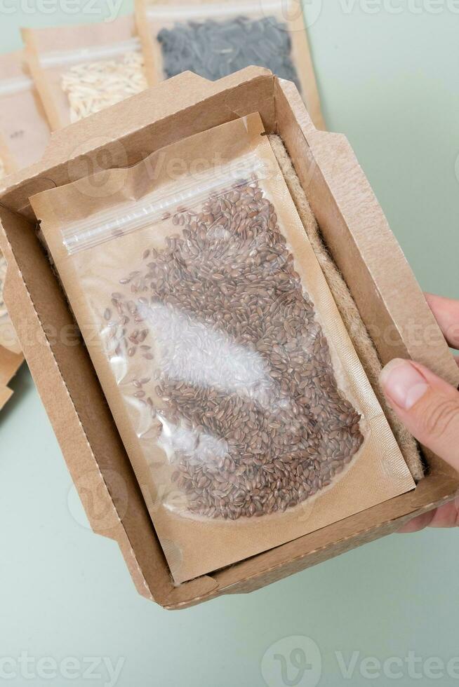 Cardboard container with linen carpet and seeds. Eco box for growing microgreens. photo