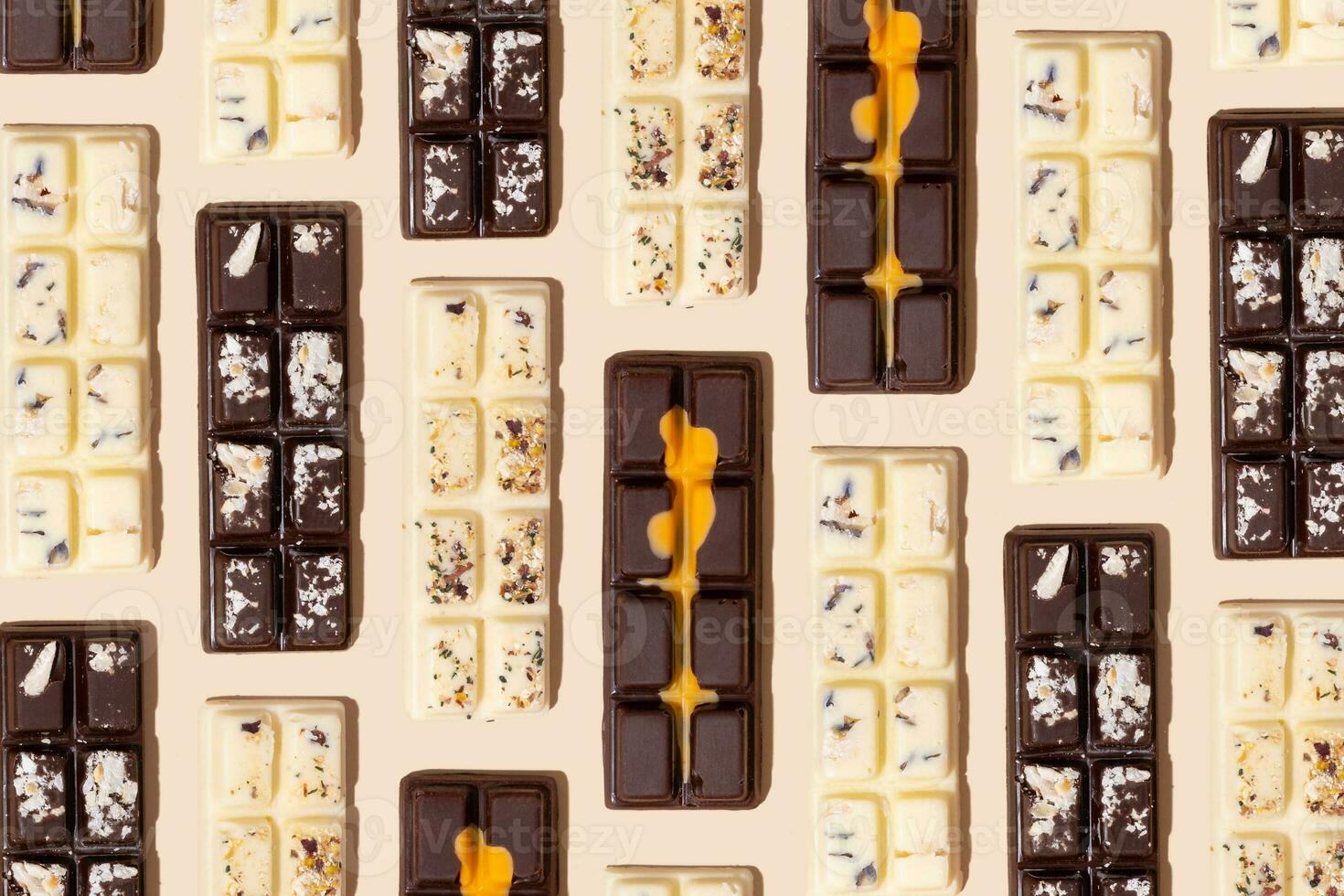 Craft white, milk and black chocolate candies pattern on beige background flat lay, top view photo