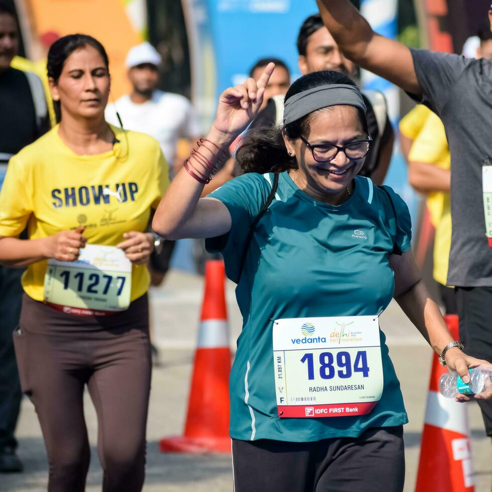 New Delhi, India - October 16 2022 - Vedanta Delhi Half Marathon race after covid in which marathon participants about to cross the finish line, Delhi Half Marathon 2022 photo