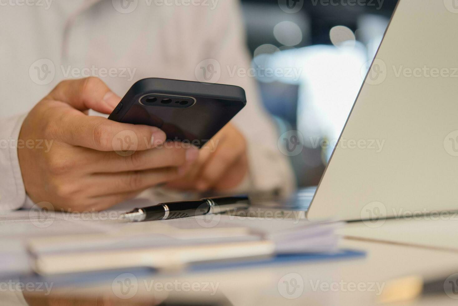 businessperson holding a mobile smartphone. work-related activity checking emails, messaging clients or coworkers, or browsing the web for research purposes. concept of technology and communication photo