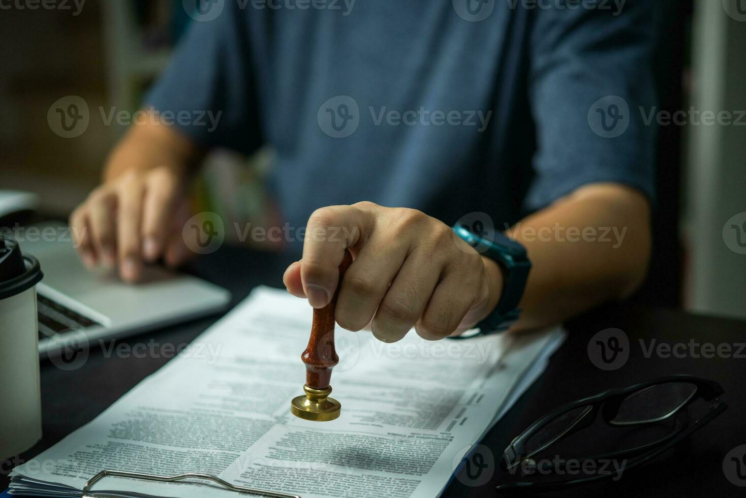 Businessman stamping with approved stamp on document contract. Business marketing investment of information law concept. photo