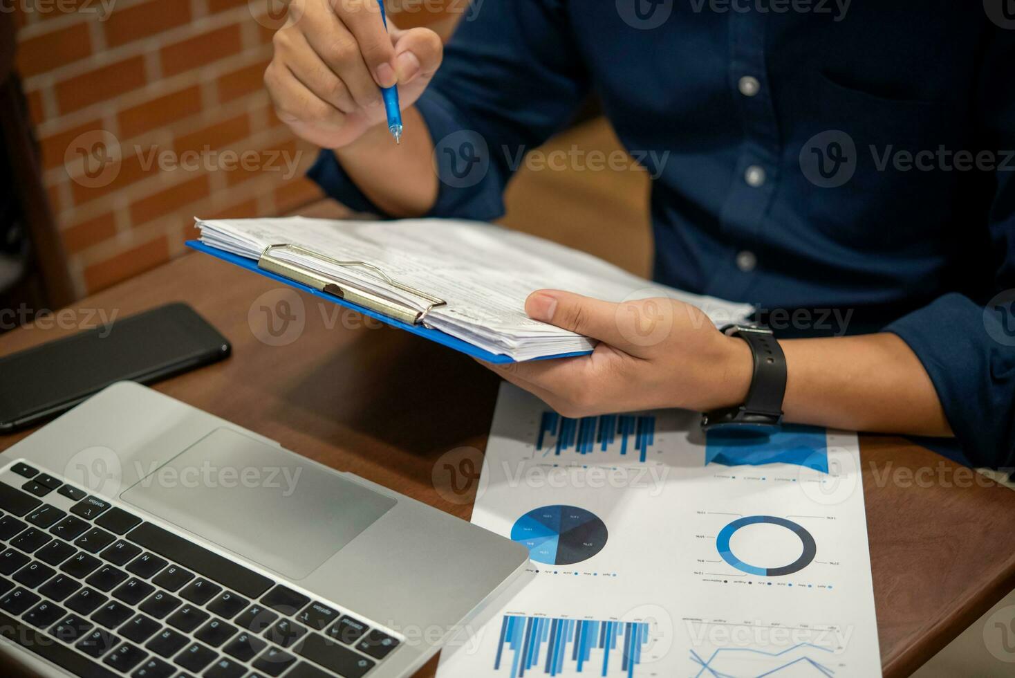 Businessman analyzing business planning, strategy, marketing and financial reports Hand Holding File, Checking reports, and reviewing business statistics. photo
