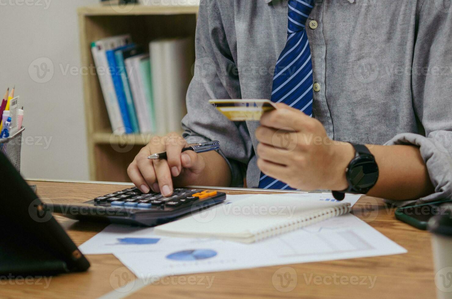 financial management and online banking applications, websites, or marketing, shopping e-commerce, including credit cards and document calculators on desk business concept. photo