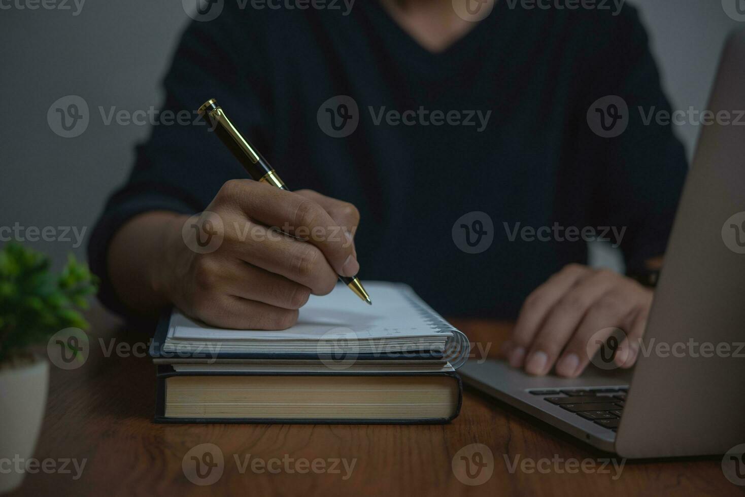 businessman working at desk, using pen and paper to Writing and Planning take notes. concepts business organization, or management, strategy, communication. photo