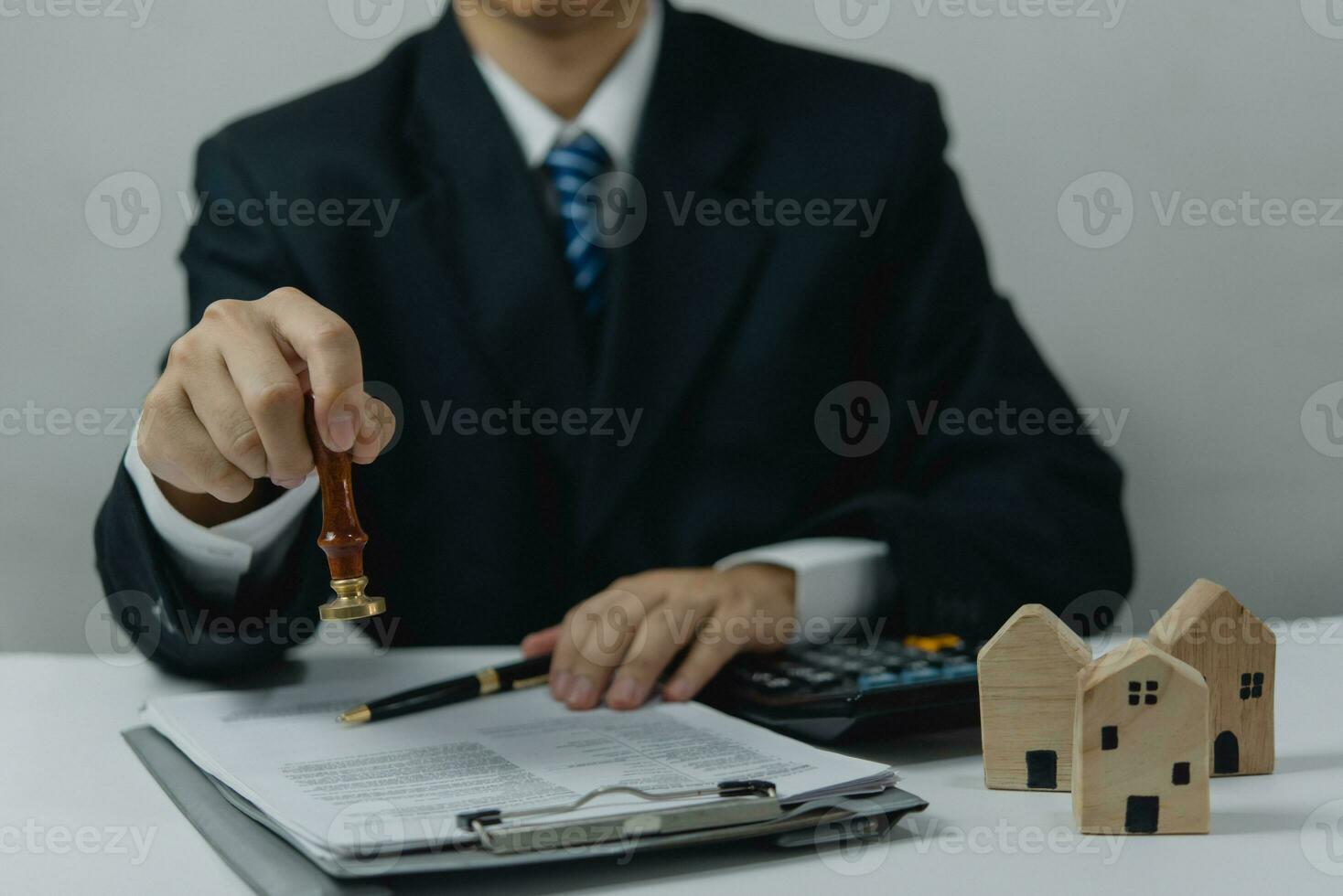 Man approving documents finance, banking, investments, marketing on desk. contract law, or rubber stamping business real estate documents, and other official and legal contracts and agreements. photo