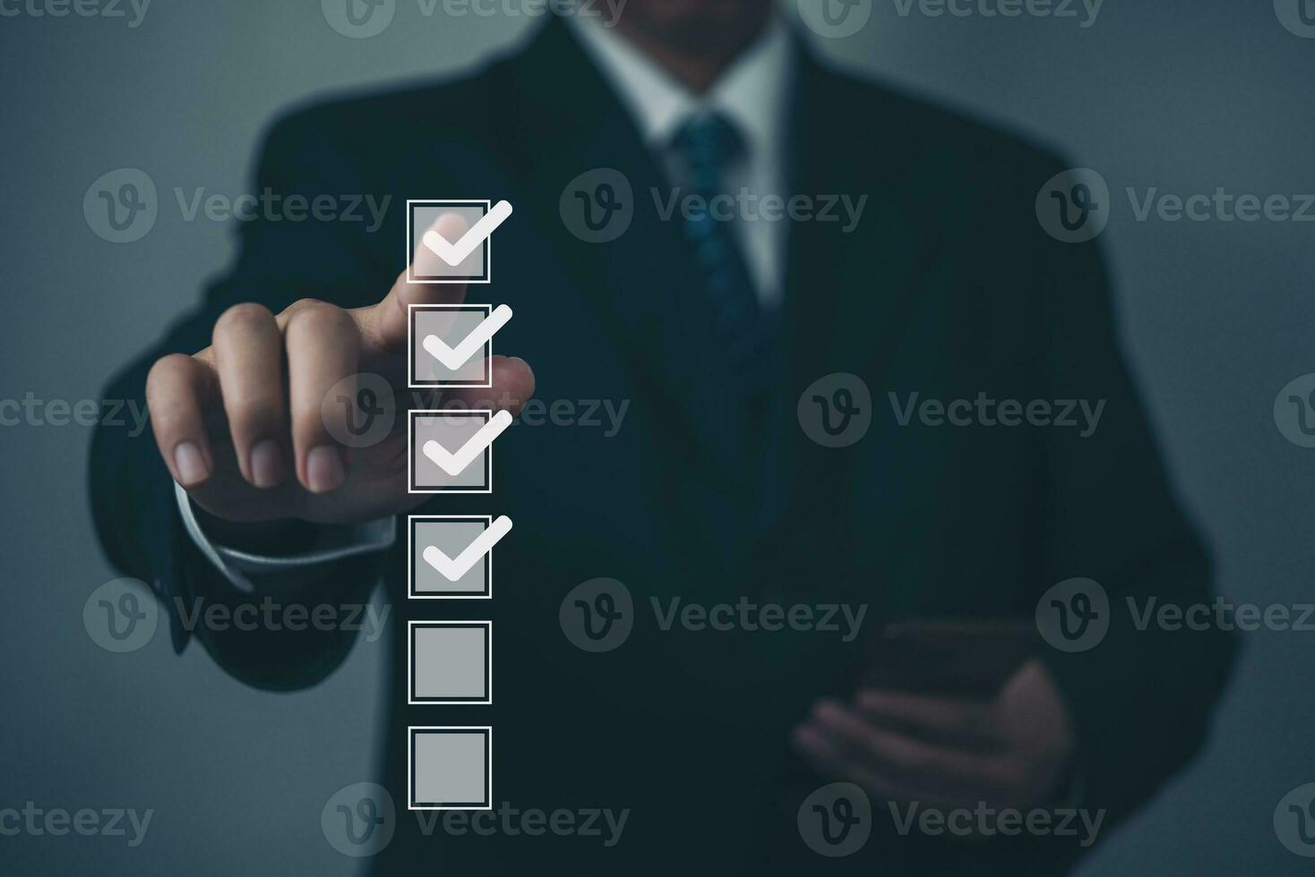 businessman using a virtual screen to check his to-do list. checking mark in a checkbox concept. photo