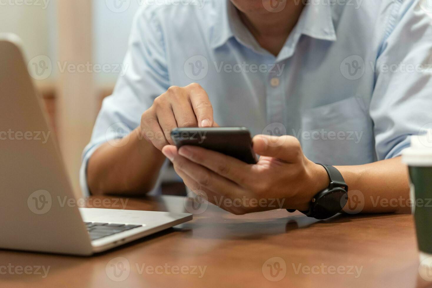 Man using touchscreen smartphone to stay connected, browse the internet, access information, and engage with social media. photo