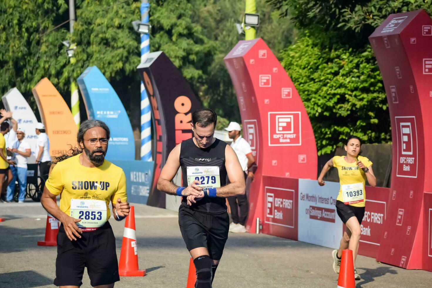 New Delhi, India - October 16 2022 - Vedanta Delhi Half Marathon race after covid in which marathon participants about to cross the finish line, Delhi Half Marathon 2022 photo