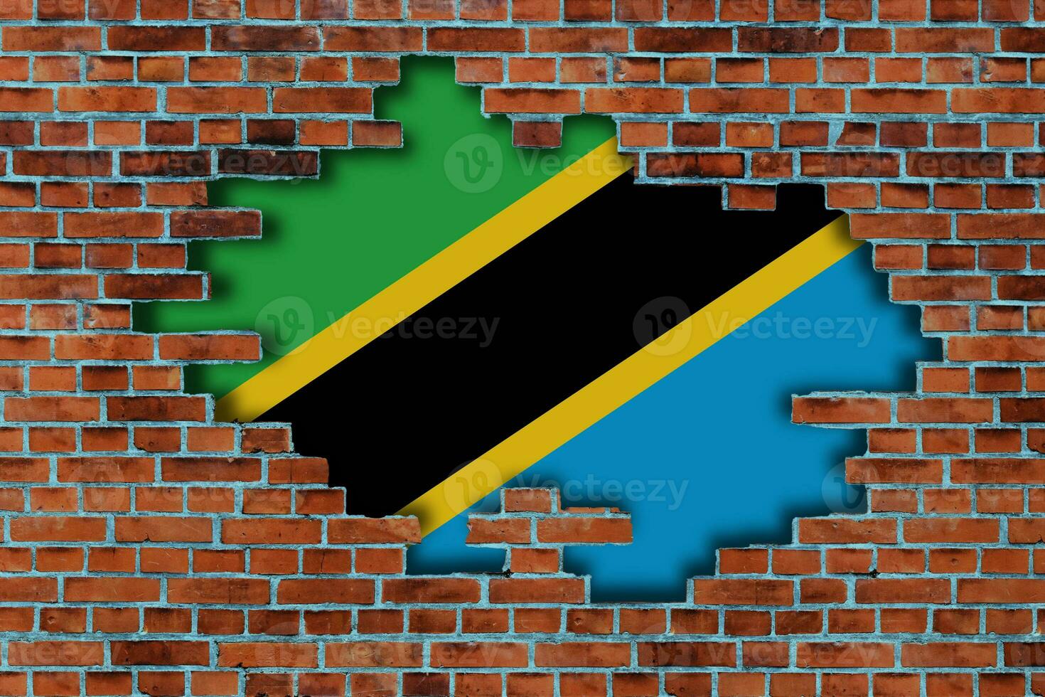 3D Flag of Tanzania behind the broken old stone wall background. photo