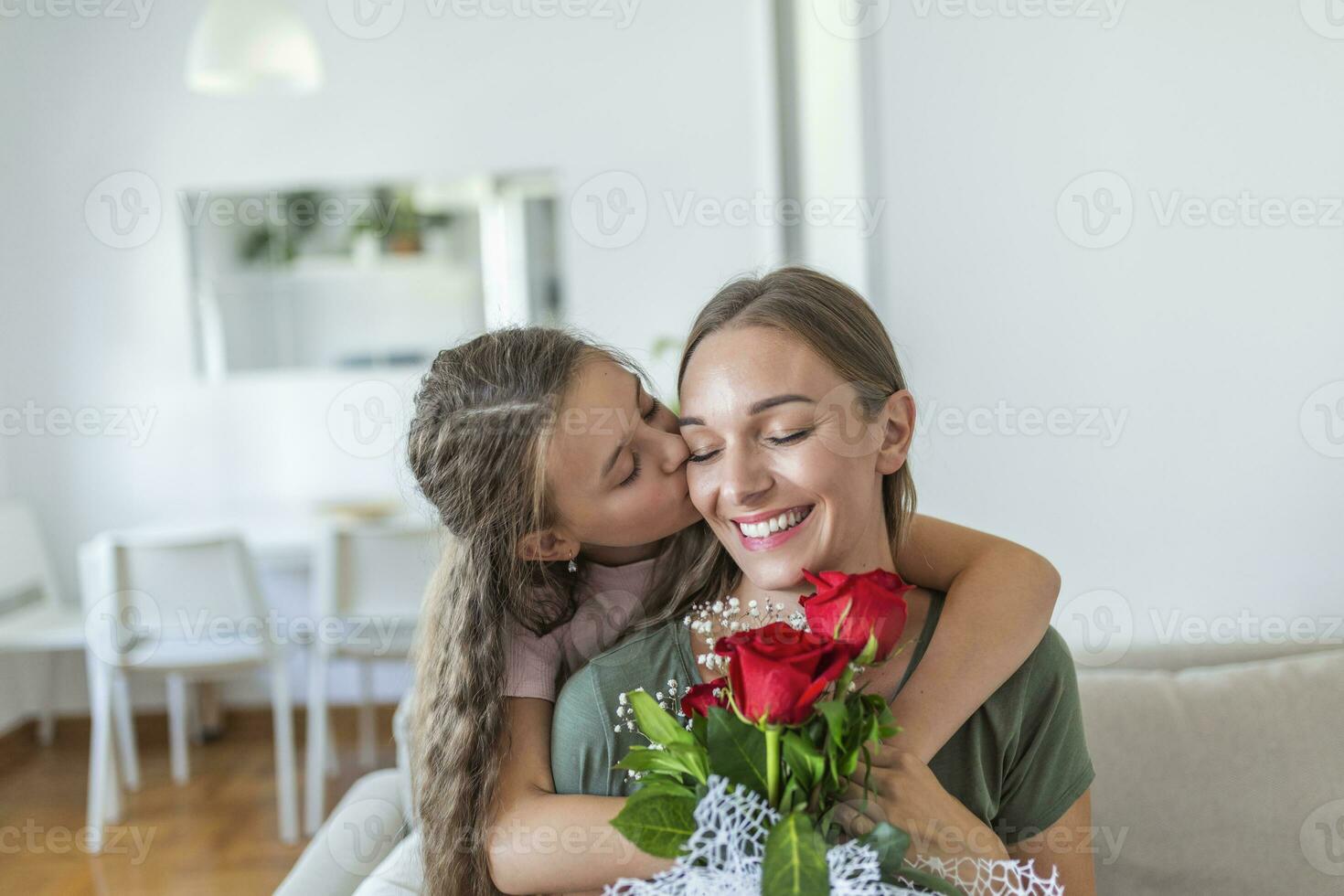 I love my you mom. Attractive young woman with little cute girl are spending time together at home, thanking for handmade card with love symbol and flowers. Happy family concept. Mother's day. photo