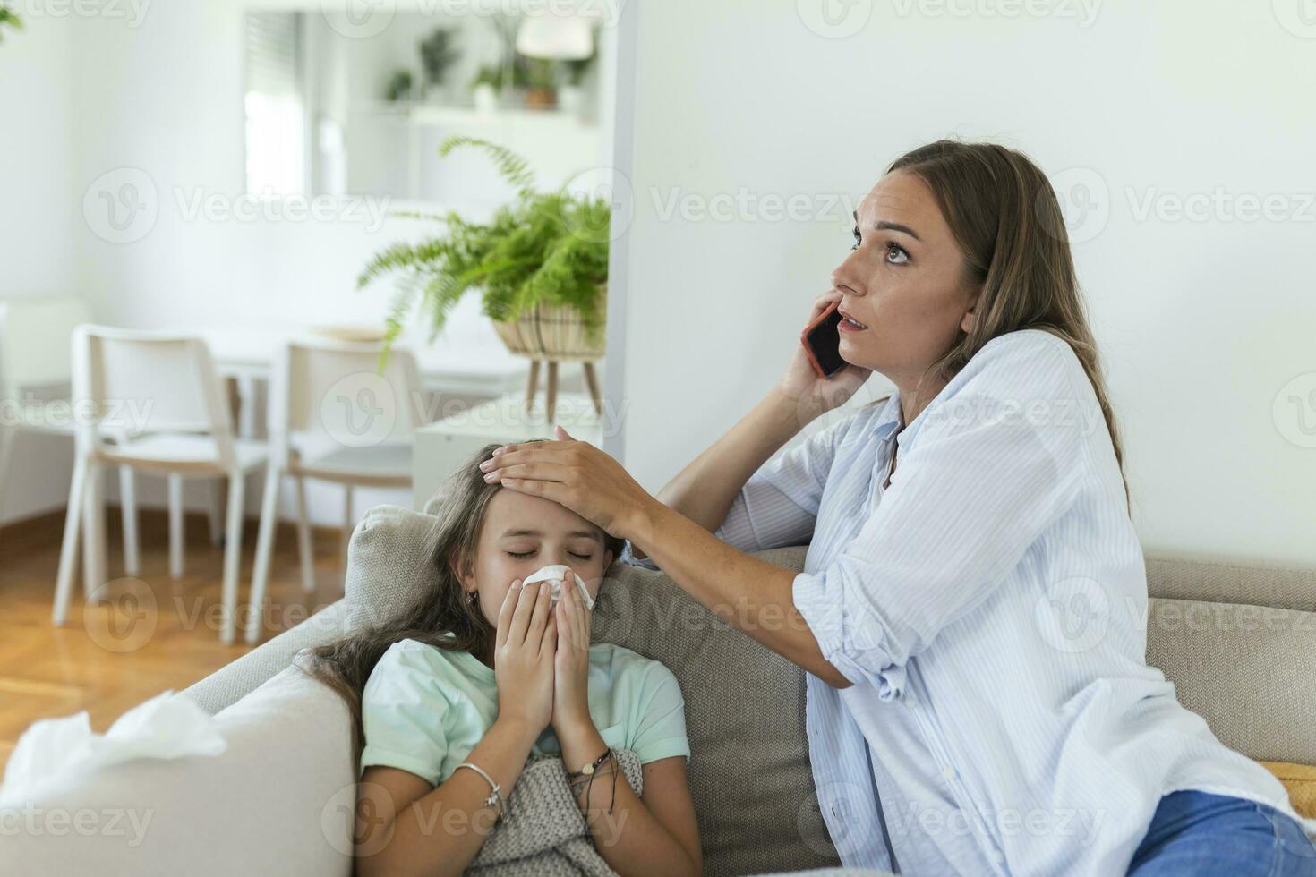 Anxious young mom call ambulance doctor take care of sick small girl child having flu and high temperature. Worried mother contact therapist or pediatrician with little daughter feel ill. photo