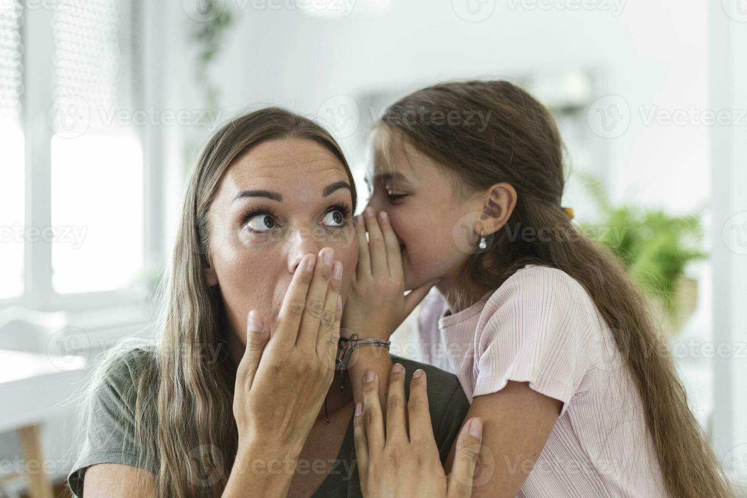 Close up image amazed mother hears incredible news from little daughter, kid girl share secret telling something interesting while mom open mouth feels surprised, trust, confidant person, fun concept photo