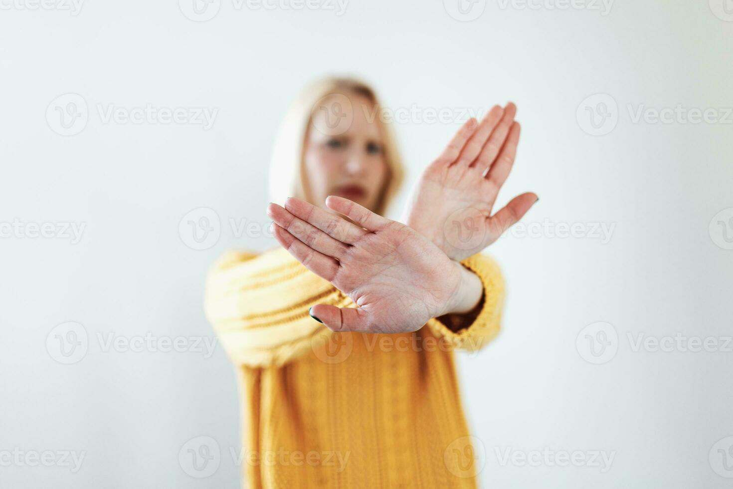 woman raised her hand for dissuade, campaign stop violence against women. Blond woman raised her hand for dissuade with copy space photo