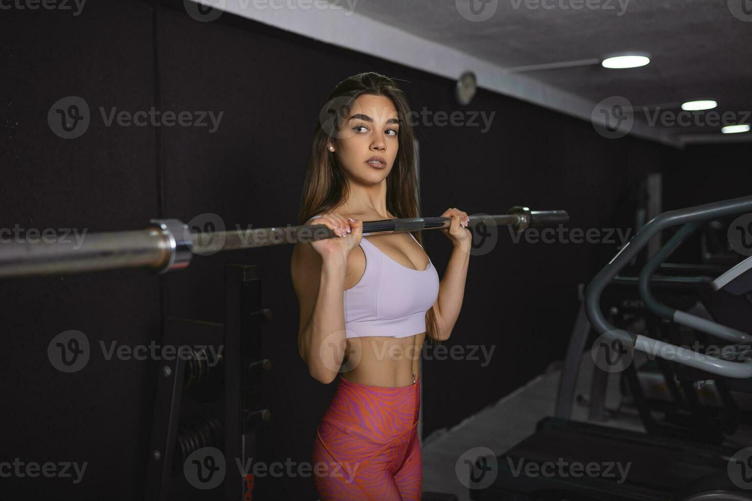 Beautiful strong sexy athletic muscular young caucasian fit woman workout training in the gym on diet pumping up muscles and posing bodybuilding health care and fitness body bar concept photo