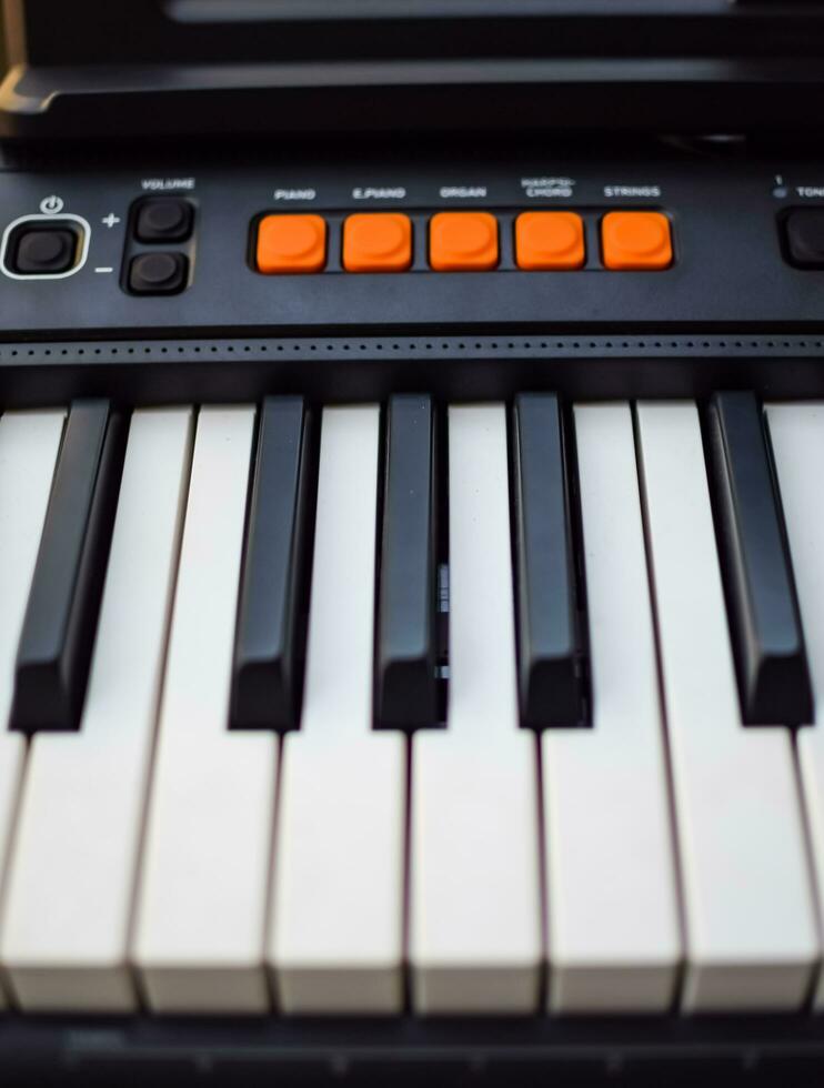 Close-up of piano keys. Piano black and white keys and Piano keyboard musical instrument placed at the home balcony during sunny day. photo