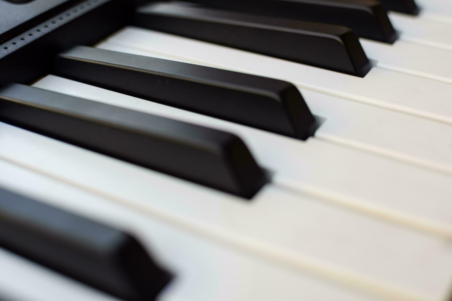 Close-up of piano keys. Piano black and white keys and Piano keyboard musical instrument placed at the home balcony during sunny day. photo