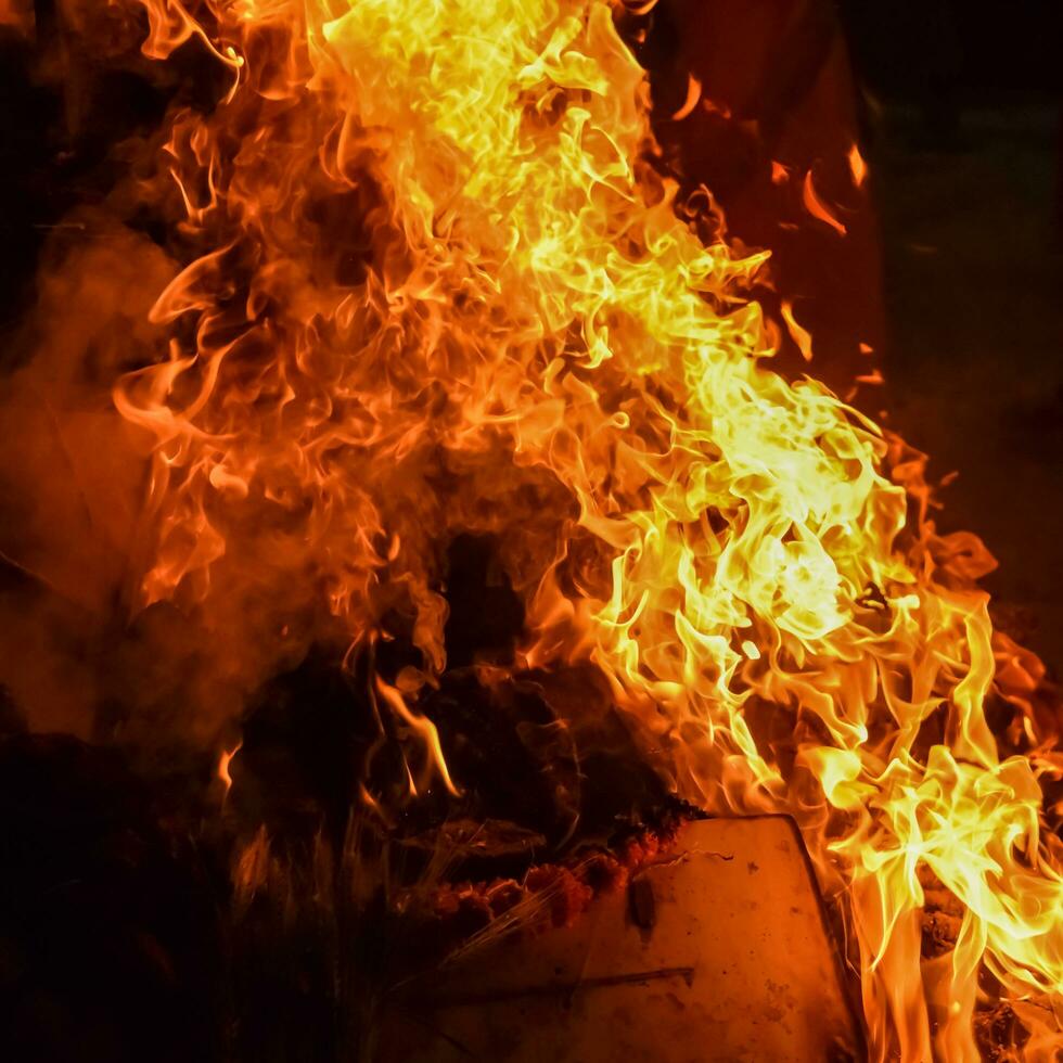 Fire flames on black background, Blaze fire flame texture background, Beautifully, the fire is burning, Fire flames with wood and cow dung bonfire photo