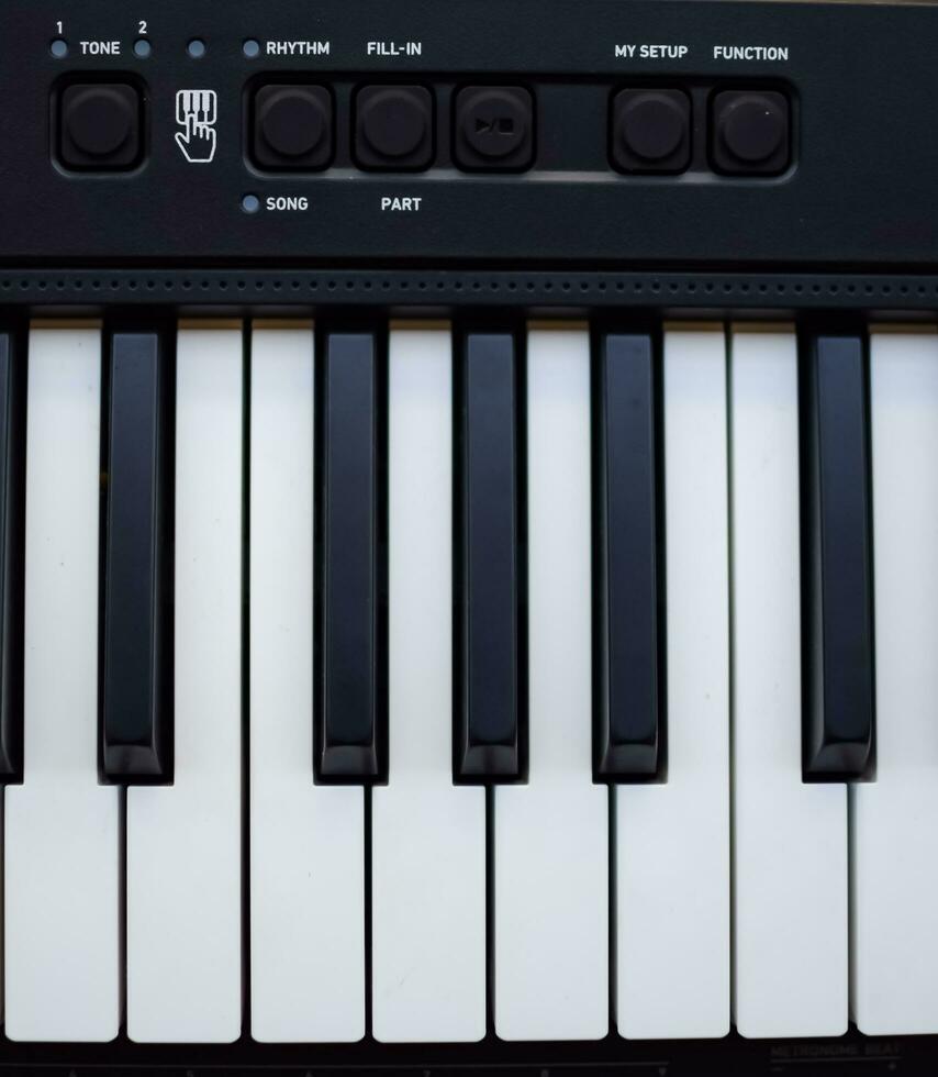 Close-up of piano keys. Piano black and white keys and Piano keyboard musical instrument placed at the home balcony during sunny day. photo