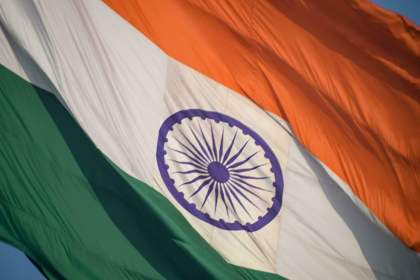 India flag flying high at Connaught Place with pride in blue sky, India flag fluttering, Indian Flag on Independence Day and Republic Day of India, tilt up shot, Waving Indian flag, Har Ghar Tiranga photo