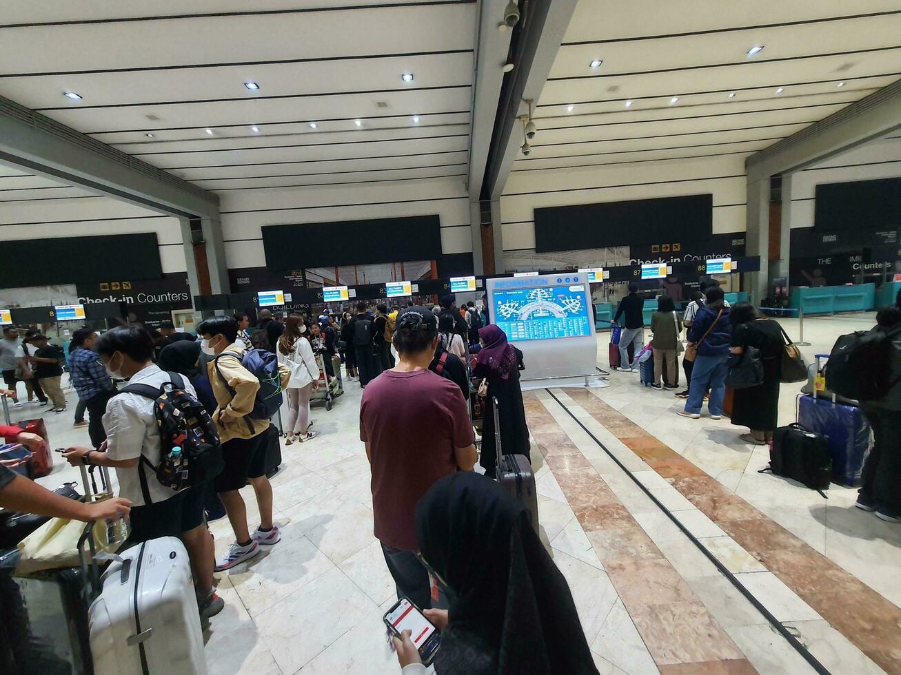 Jakarta, Indonesia on May 21, 2023. People are queuing at the check-in counter in Terminal 2F of Soekarno Hatta Airport CGK photo