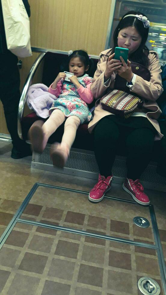 Osaka, Japan on April 2019. Feet of a mother and a child on a train in Japan. photo