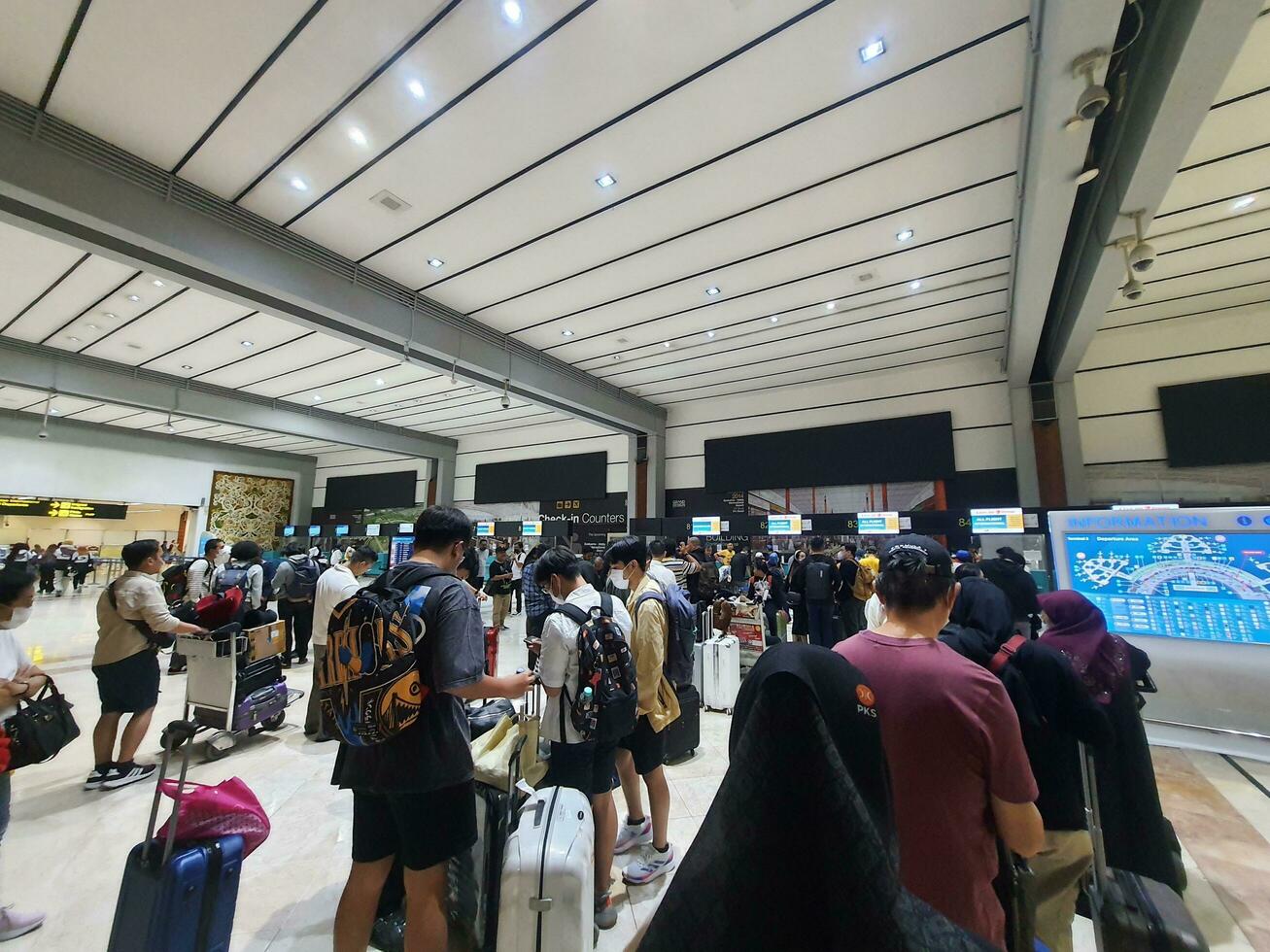 Jakarta, Indonesia on May 21, 2023. People are queuing at the check-in counter in Terminal 2F of Soekarno Hatta Airport CGK photo